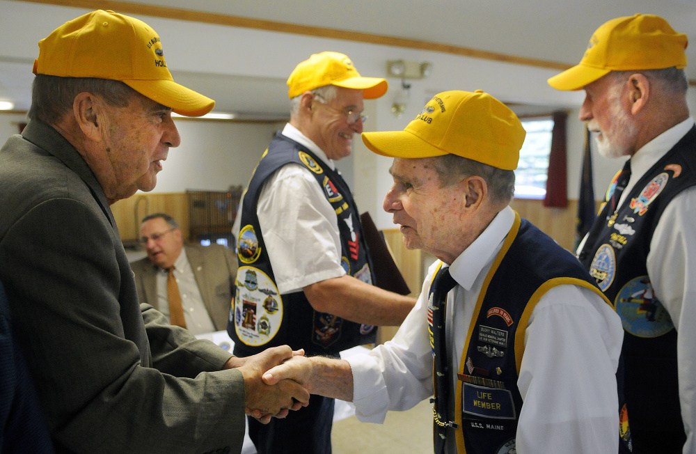 AUGUSTA, ME - SEPTEMBER 20: John Morris, left, is congratulated Sunday September 20, 2015 by Bucky Walters as Willis Clifford, right, congratulates Paul Talbot for their nomination to the The Holland Club, for submariners who survived 50 years after going to sea on a submersible boat, during a ceremony in Augusta.  Morris, Maine's Public Safety Commissioner and a resident of West Gardiner, served on the USS Tunny in 1965.  Talbot, a resident of Corinna, first qualified aboard the USS Clamagore in 1964.  Gov. Paul LePage, second from left, attended the event. (Staff photo by Andy Molloy/Staff Photographer)