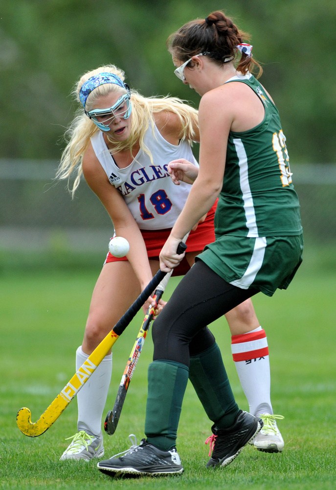 Messalonskee High School’s Nathalie St. Pierre (18) fights for the ball with Oxford Hills High School’s Sydney Jackson (13) in the first half at Messalonskee High School in Oakland on Tuesday.