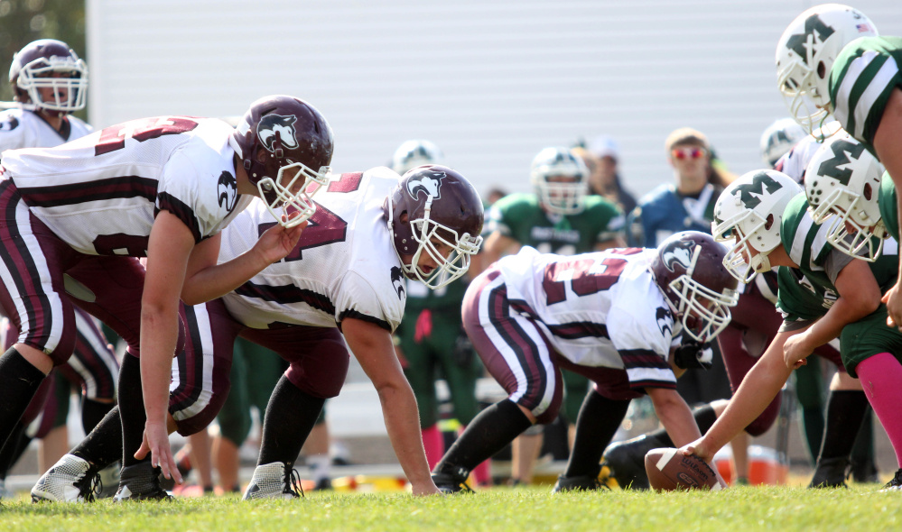 Photo by Jeff Pouland 
 Maine Central Institute's Curtis McLeod waits for the snap during the third quarter of last Saturday's game against Mount View High School in Thorndike.