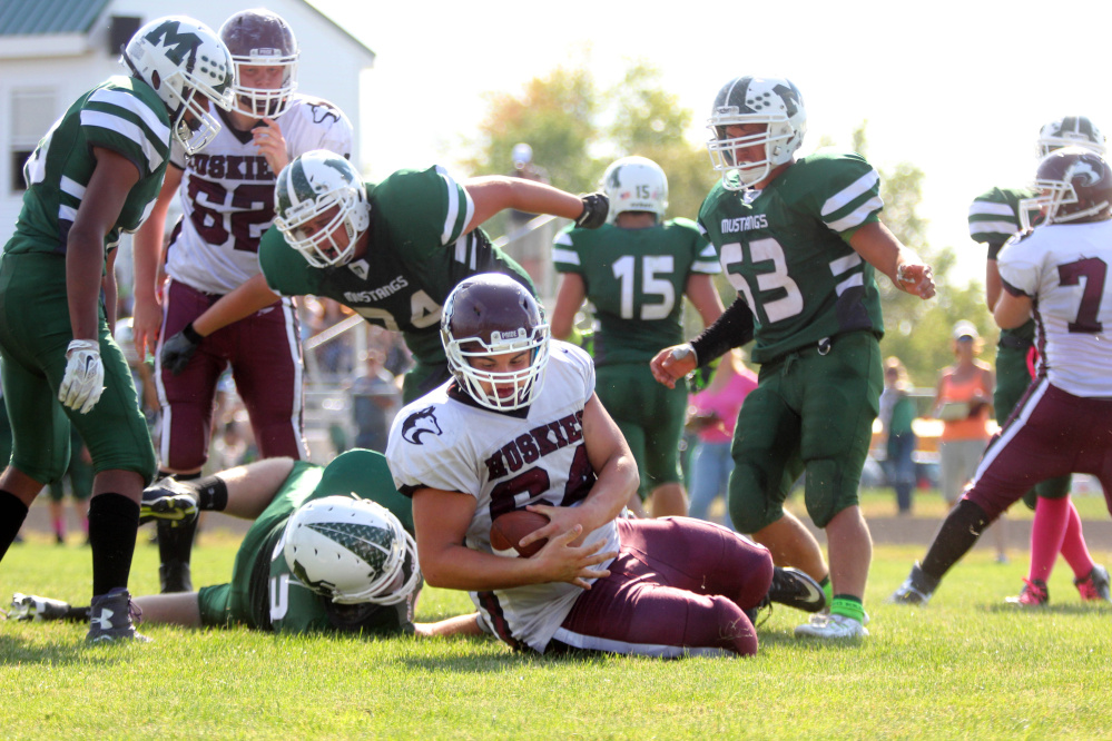 Photo by Jeff Pouland 
 Maine Central Institute's Curtis McLeod hauls in a two-point conversion during the third quarter of last Saturday's game against Mount View High School in Thorndike. McLeod plays offensive and defensive tackle for the Huskies.