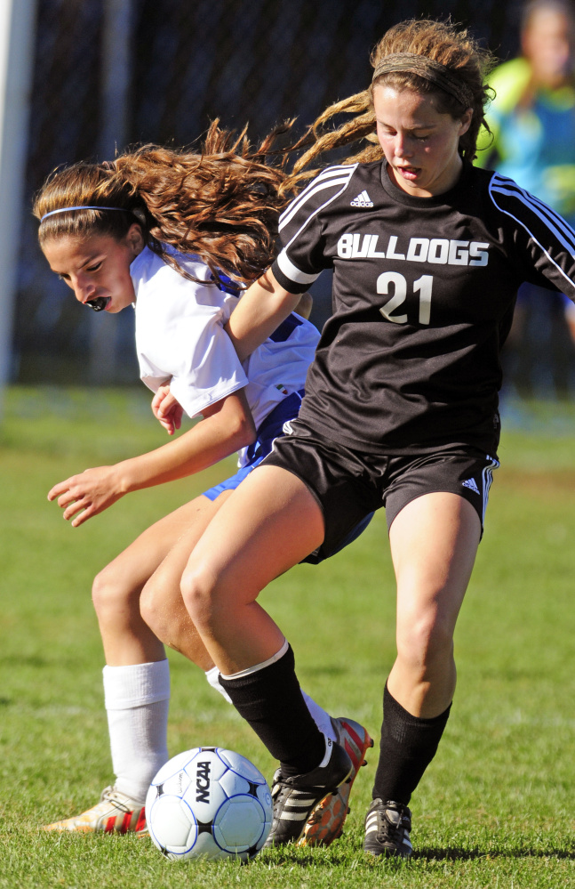 Oak Hill’s Abby Deslaurias (28), left, and Hall-Dale’s Signe Lynch (21) battle for ball during a game Wednesday in Wales.
