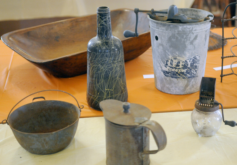 Items on display at the Manchester Grange on Thursday in preparation for an exhibit by the Manchester Historical Society on Sunday.