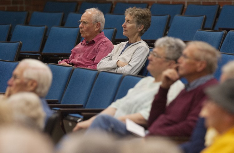 Michael Levey, left, and Michael Brown, both of Winthrop, listen during a public forum on end-of-life decisions held at Jewett Auditorium at the University of Maine in Augusta on Sunday.