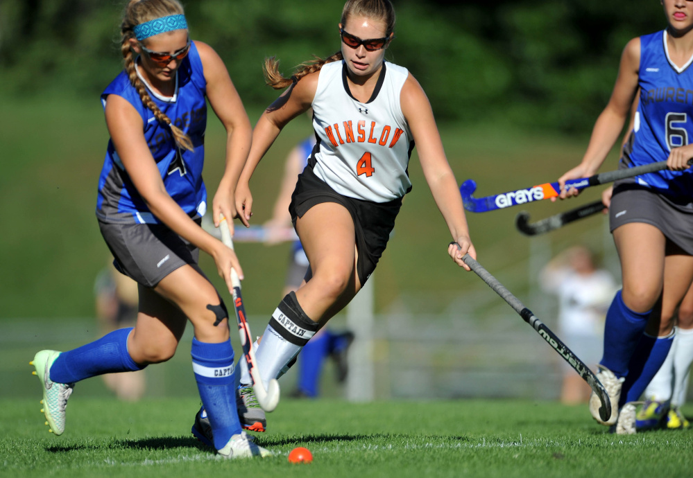 Michael G. Seamans 
 Winslow's Jessica Greeley (4) defends Lawrence's McKenna Rogers, left, during the first half of a Class B North game last Thursday. Greeley and the Raiders are moving up the standings after big wins over Lawrence and Gardiner.