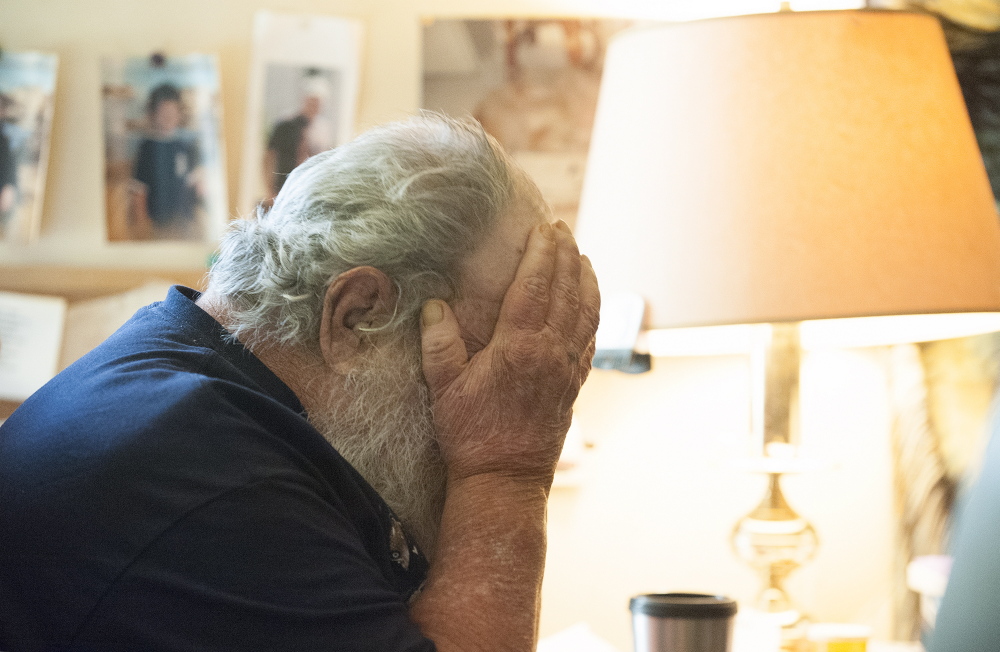 Sitting in his living room Tuesday, Harvey Lembo demonstrates how an intruder acted, frequently looking down and covering his face, as Lembo pointed a gun at him while waiting for police to arrive. “I don’t know what he was on, but he was out of his mind,” Lembo said. When the intruder bolted for the door, Lembo wounded him.