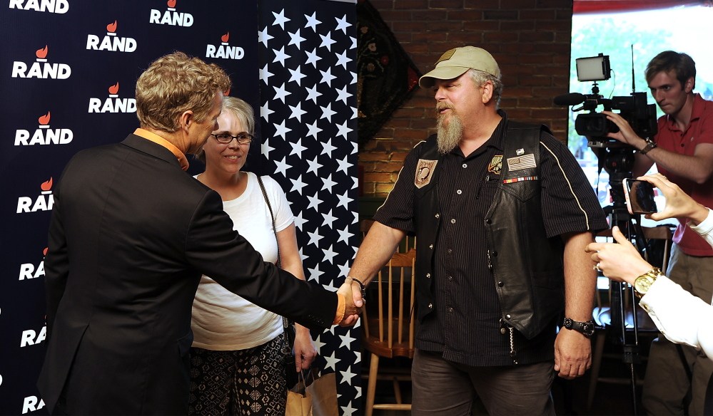 Rand Paul shakes hands with Joe Scanlon of Topsham before Scanlon and his wife, Catherine, get a photo with the candidate.