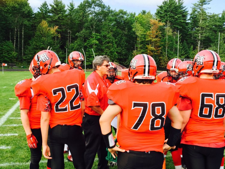 Camden Hills coach Thad Chilton talks to his players on Sept. 19 at the school in Rockport where the Jammers played Bucksport. The school has canceled the rest of its football season because it has too few players.