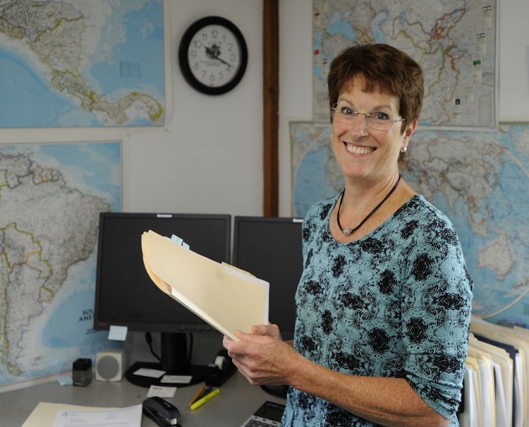 In an office lined with maps, Planson International President Connie Justice says the company's job is to come up with the best technology solution at the lowest possible price.