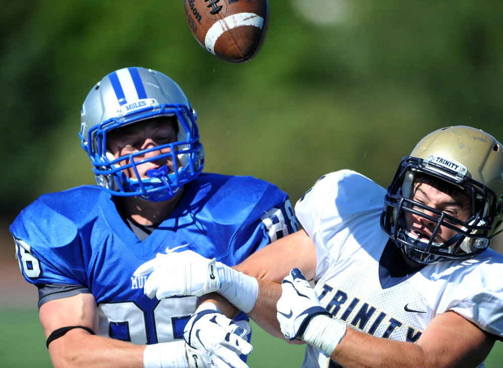 Trinity’s Paul McCarthy (32) breaks up a pass intended for Colby’s Mark Snyder last Saturday. The Mules return to action Saturday at Middlebury.