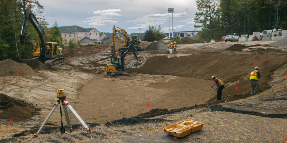 McGee Construction workers build the sides of the entrance road Friday at the construction site of the new National Guard headquarters on Civic Center Drive in Augusta.