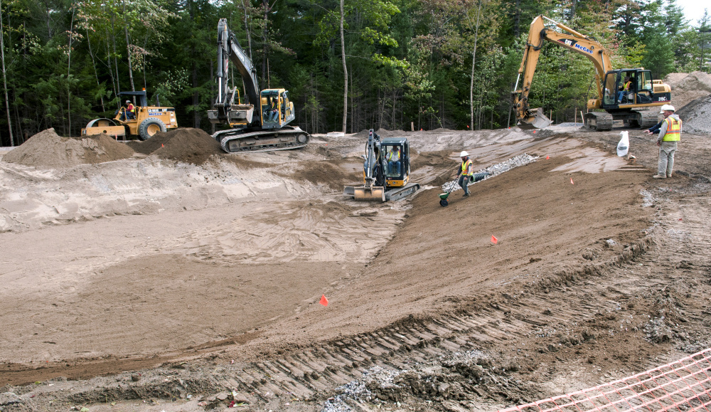 McGee Construction workers build the sides of the entrance road Friday at the construction site of the new National Guard headquarters on Civic Center Drive.
