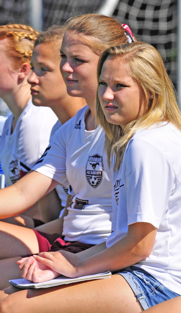 Staff photo by Joe Phelan 
 Monmouth Academy senior Olivia Homer, right, keeps the scorebook during a Sept. 19 homecoming game. Homer was one of the top defenders for the Mustangs, but she decided against playing this fall because she fears what another concussion would do to her quality of life.