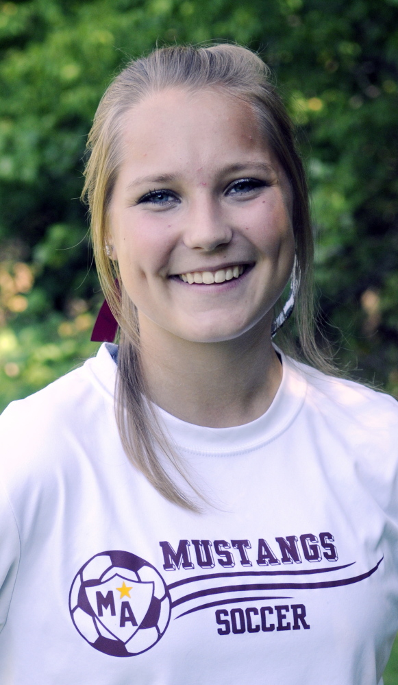Staff photo by Joe Phelan 
 Monmouth Academy soccer player Olivia Homer doesn't play soccer anymore, but she keeps the scorebook for the Mustangs.