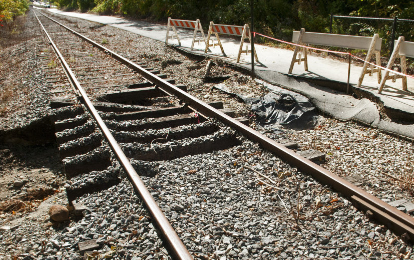 Barricades block off the collapsed trail surface at one of two washed out sections of the Kennebec River Rail Trail on Monday in Farmingdale.