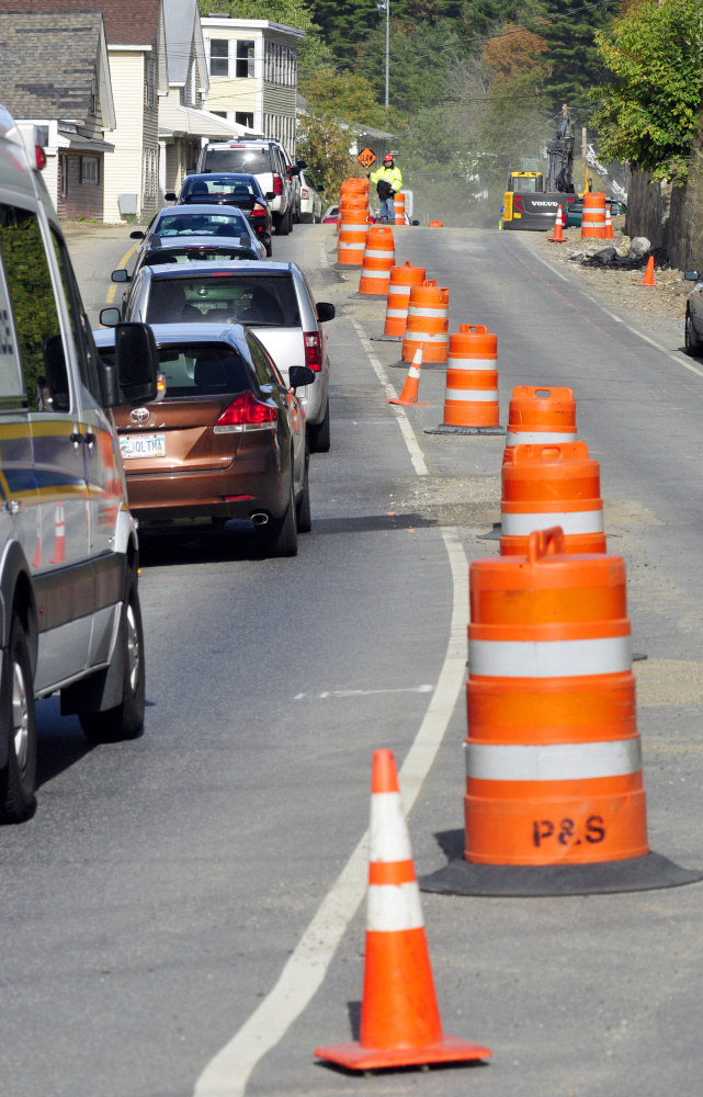 A flagger directs traffic on Monday in the one-way section of Mount Vernon Avenue in Augusta.