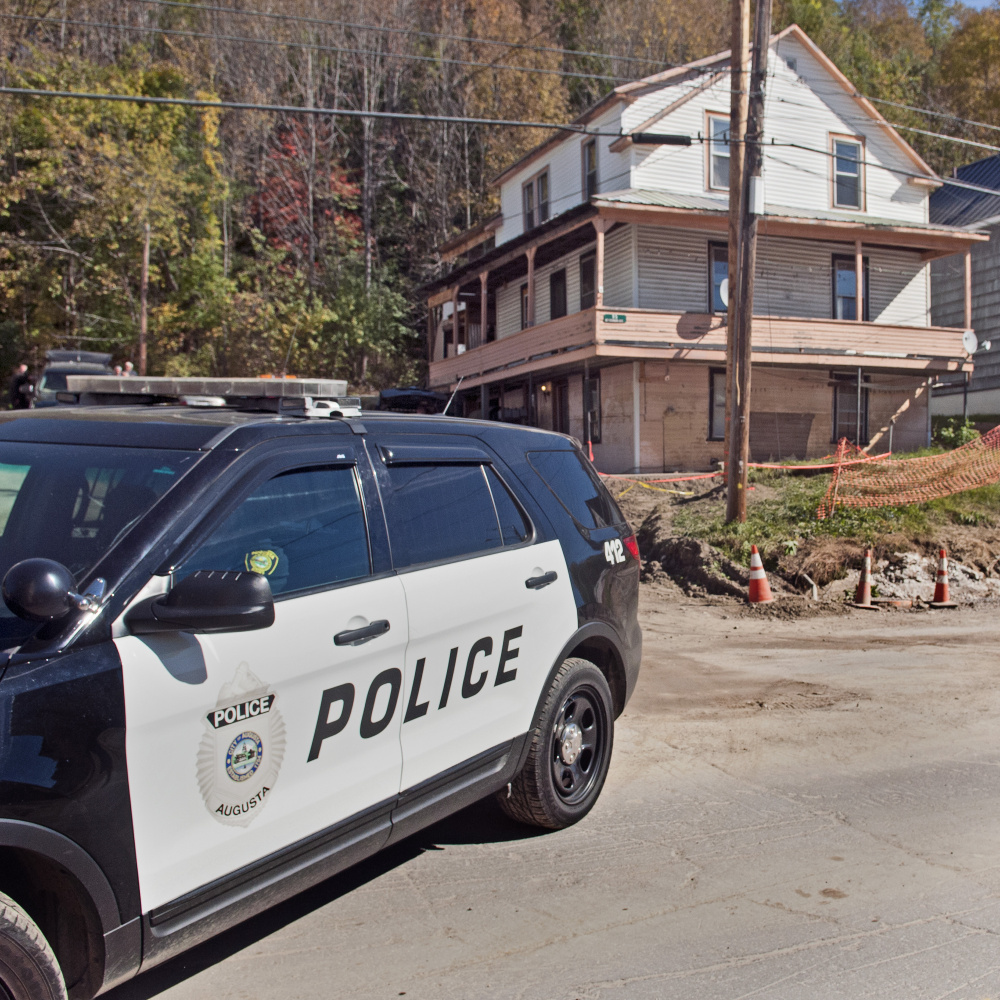 Investigators leave 95 Mount Vernon Ave. in Augusta on Thursday.