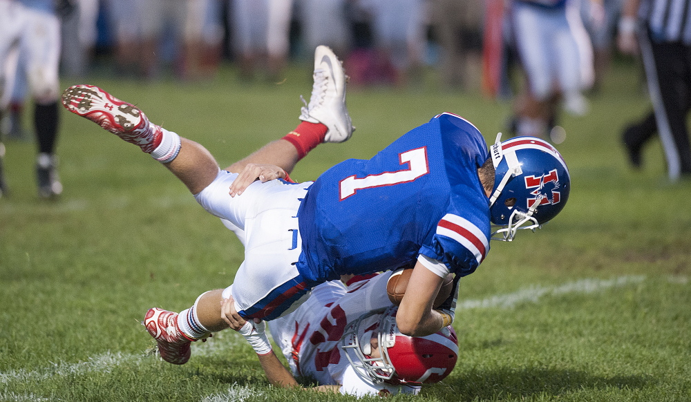 Photo by Kevin Bennett 
 Messalonskee running back Colby Dexter gets wrapped up by Cony's Lucas Tyler during a Pine Tree COnference Week 2 game in Oakland. The Eagles visit Skowhegan on Friday in a key PTC B showdown.