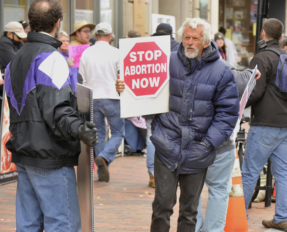 Abortion opponents line up outside the Planned Parenthood office in Portland on Saturday to call for an end to the public funding of the organization.