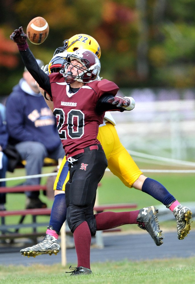Nokomis High School’s Colby Penette (20) breaks up a pass intended for Mt. Blue High School’s Zach Meader (22) on Saturday in Newport.