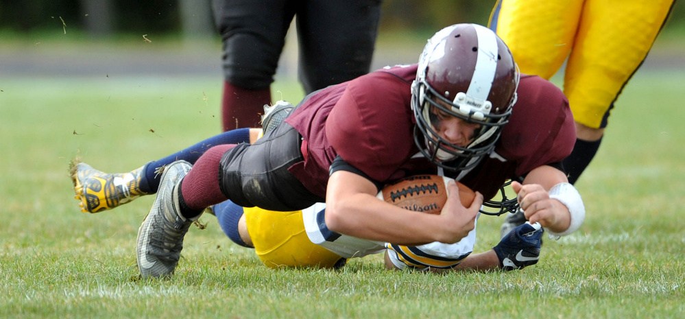Nokomis High School’s Brock Graves (12) dives for extra yards against Mt. Blue High School on Saturday in Newport.