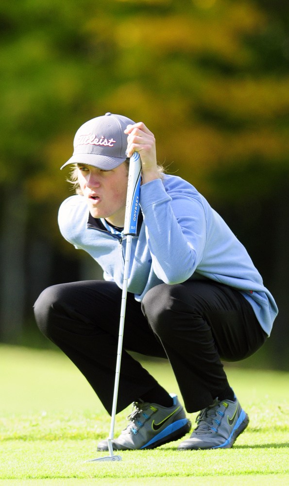 Messalonskee’s Dylan Burton lines up a putt on the third green of Tomahawk during the state team golf tournament Saturday at Natanis Golf Club in Vassalboro.