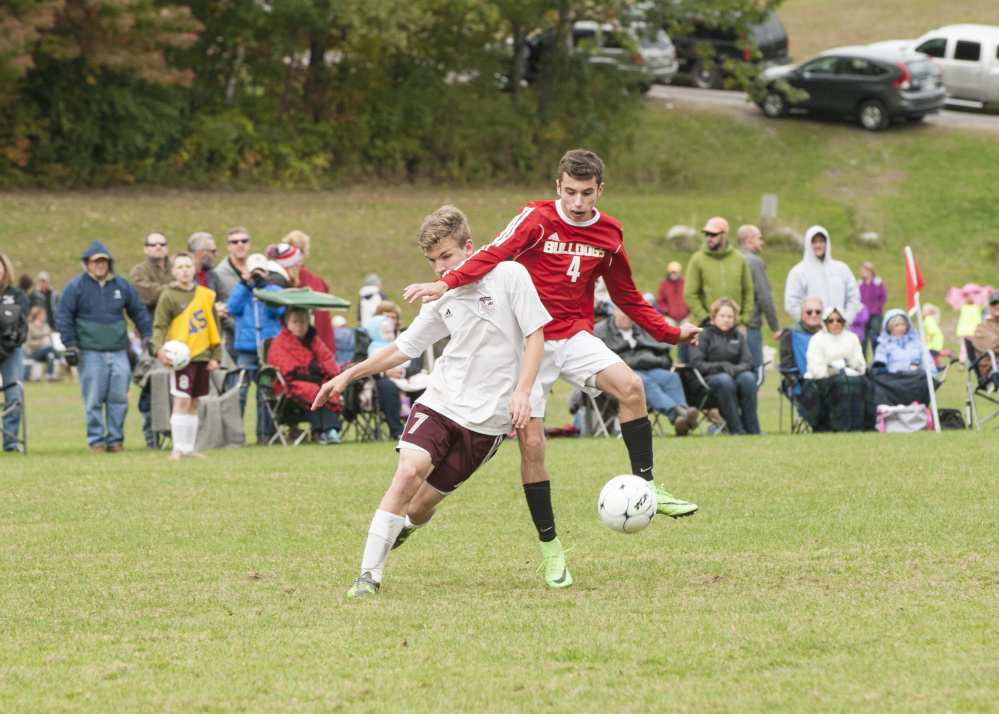 Hall Dale’s Tyler Nadeau, right, tries to keep the ball from Monmouth’s Shane Kenniston during a game Saturday in Monmouth.