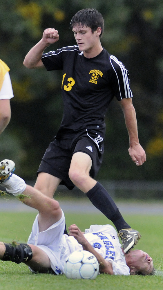 Staff photo by Andy Molloy 
 Maranacook's Kent Mohlar steps gently over Erskine's Trevor Hubbard during a Class B game Tuesday in South China. Maranacook won, 2-1.