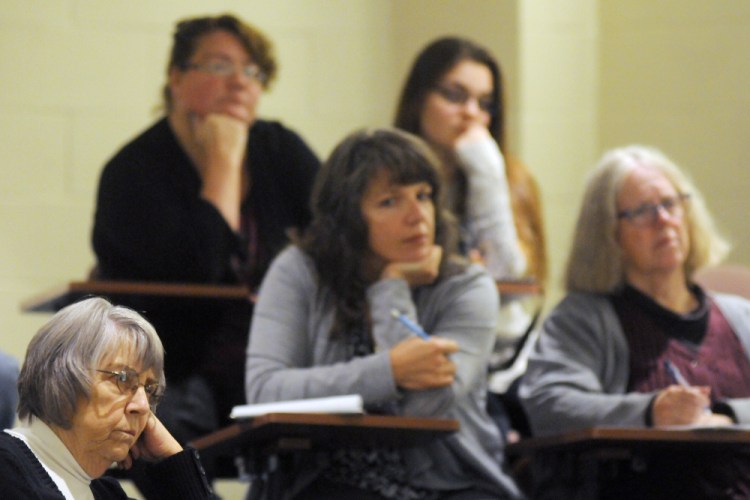 People listen to a discussion Tuesday at City Center in Augusta about combating childhood hunger and homelessness.er)