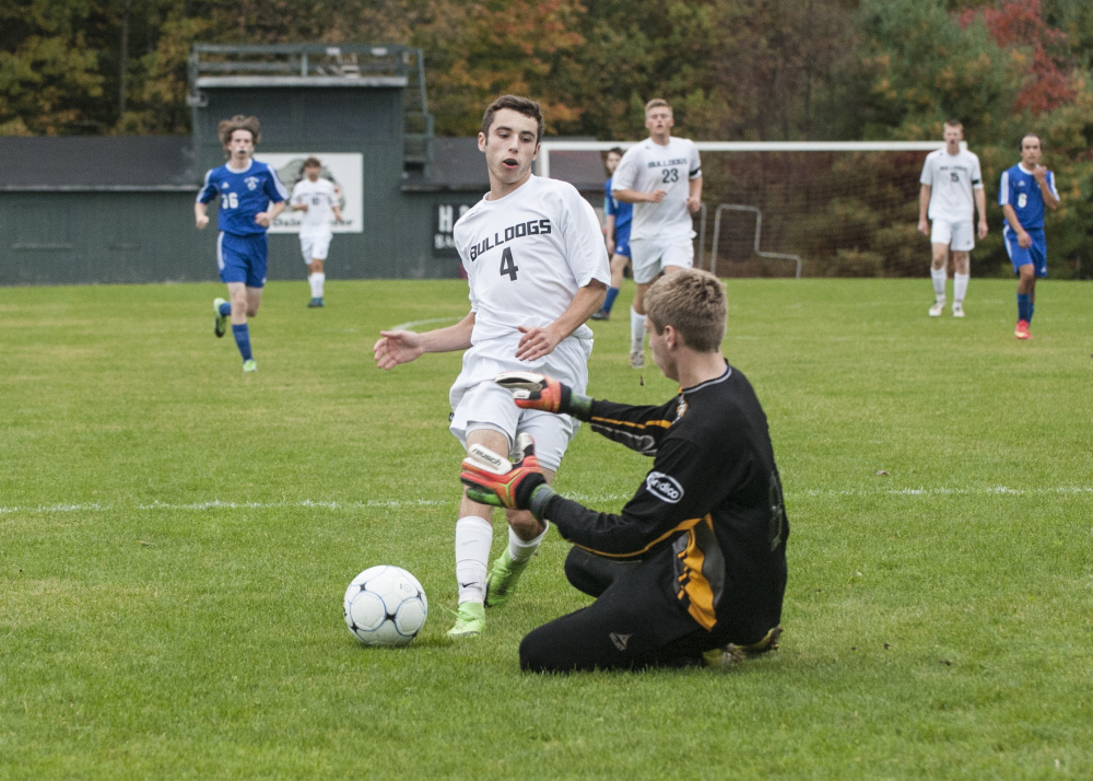 Contributed photo/Marty Thornton
Hall-Dale’s Tyler Nadeau shoots on Mt. Abram keeper Seth Thomas during a Mountain Valley Conference game Tuesday in Farmingdale.