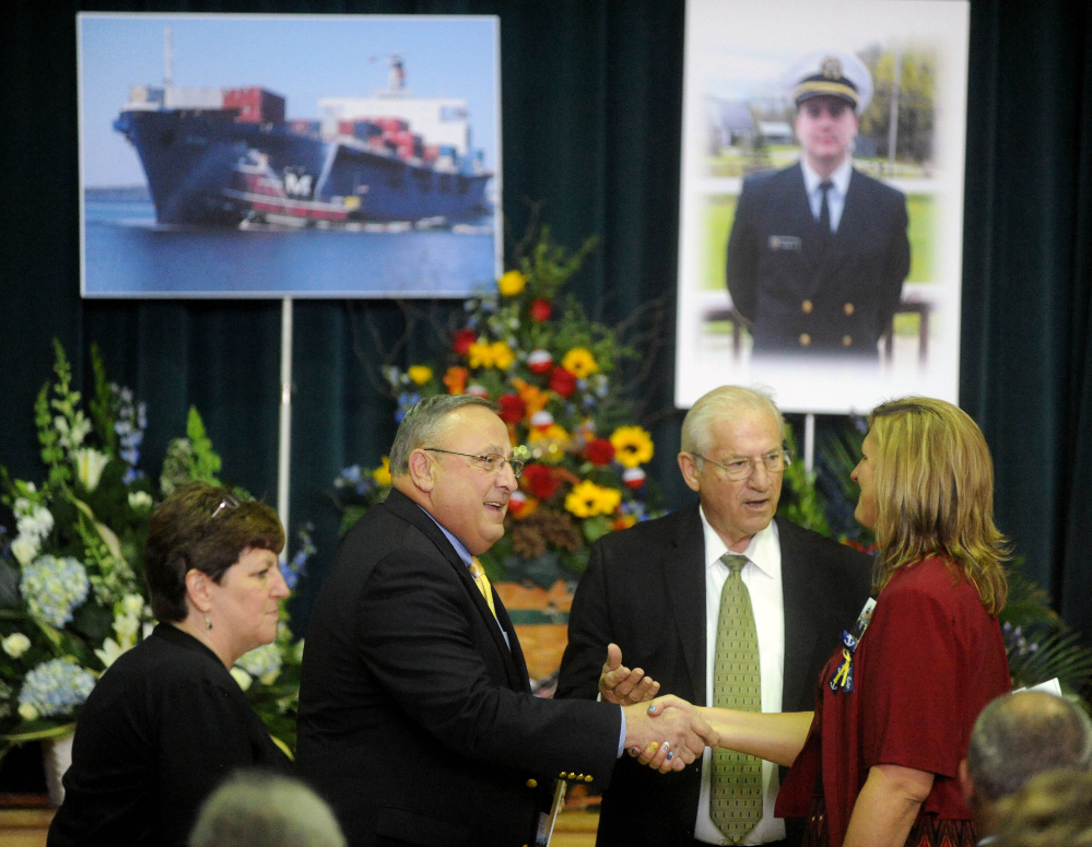 Gov. Paul LePage pays his respects to Deborah Holland Roberts, mother of Michael Holland, during a celebration of Holland’s life at the Jay Community Building on Wednesday.