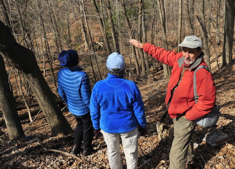 Sue Bell, left, city councilor Dale McCormick and Brian Kent look down on Kennedy Brook during a walking tour of Howard Hill on Friday April 18, 2014 in Augusta. The wooded hill is backdrop to the State House.