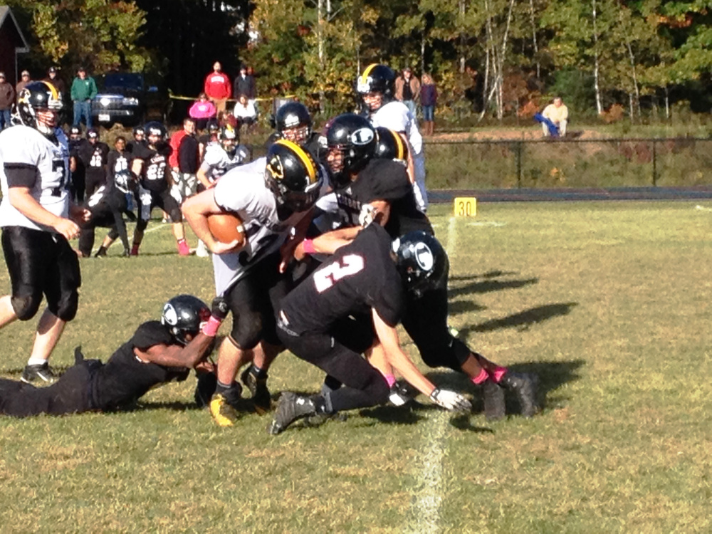 Maranacook quarterback Kyle Morand is stopped by a wall of Lisbon defenders during a Campbell Conference Class D game Saturday at Thompson Field in Lisbon.