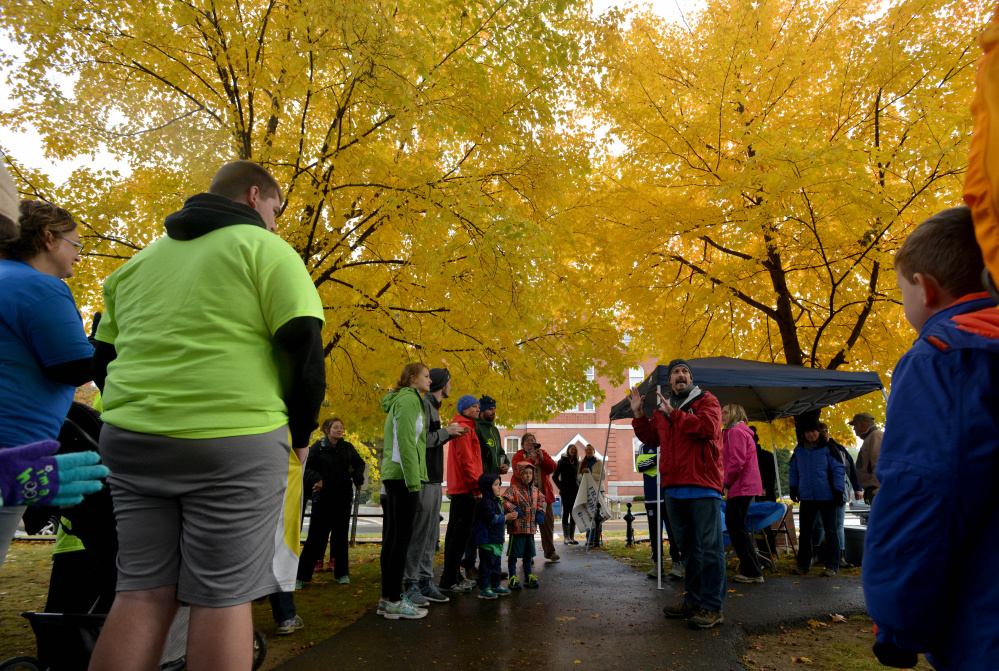 Doug Saunders, right center, addresses the crowd before a fundraising walk hosted by the Franklin County Children’s Task Force on Saturday in Farmington to support child-abuse prevention programs.