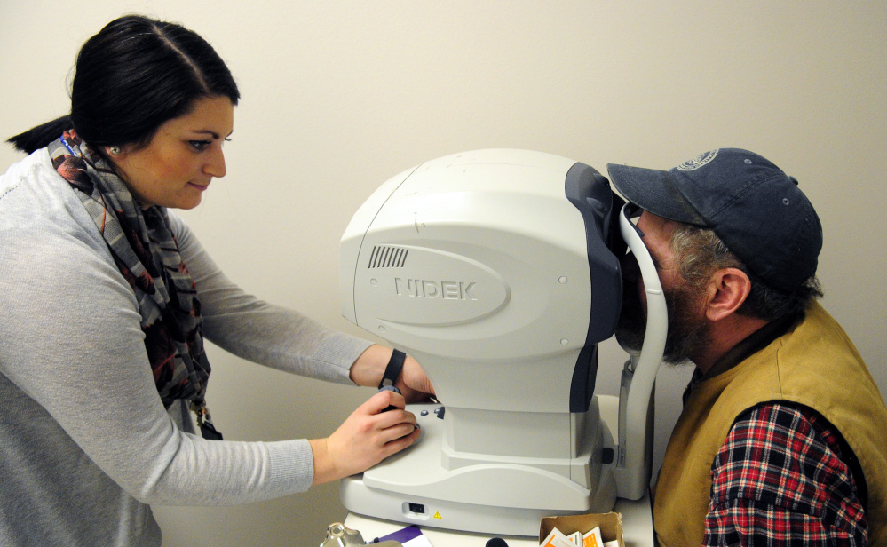 Marie Mantelli, left, does an eye examination of Rob Gaston, of Waldoboro, during the 18th annual Homeless Veterans Stand Down on Saturday VA Maine Healthcare System-Togus.