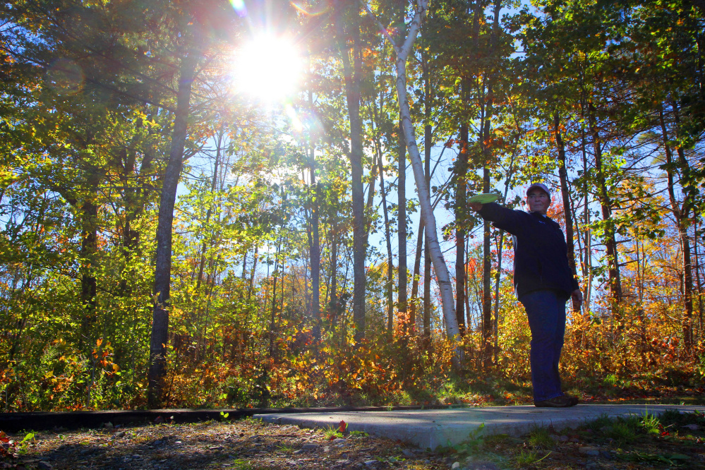 Cathy McDevitt of West Gardiner lines up her tee shot on No. 6 during the 2nd annual Porcupine Ridge PDGA Open at Porcupine Ridge on Sunday in Augusta.