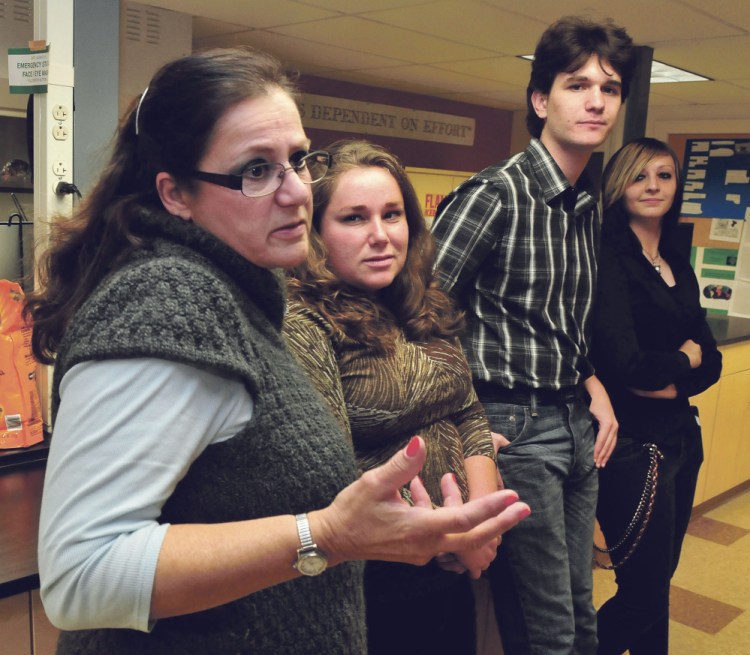 Unity College professor Wilma Lombardi and students, from left, Jenna Rippee, Henry Symanski and Grace Wilson, speak about a survey with 14 solid waste questions they created that will be given to Winslow residents on Election Day.