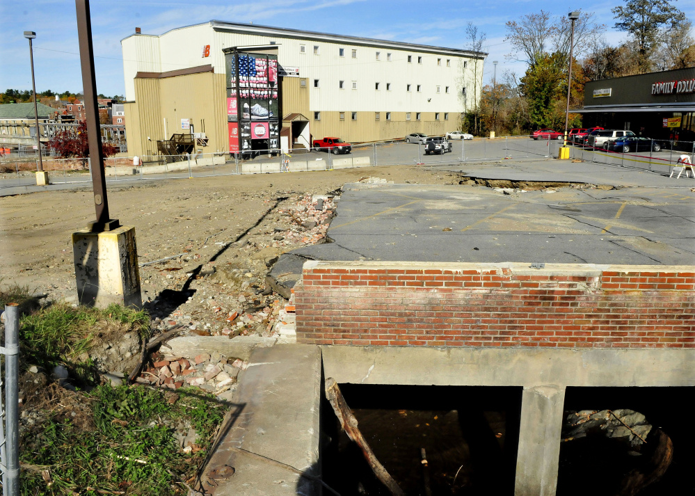 The parking lot at Skowhegan Plaza still shows the damage from a Sept. 30 storm. Parking remains partially blocked off since the storm, which forced Ginny’s Natural Corner to move earlier than the owner had planned.