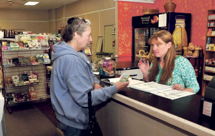 Ginny’s store owner Ginny Jewell, right, waits on customer Irene Quirion at the new location at 78 Water St. in Skowhegan on Wednesday. Jewell was already moving out of Skowhegan Plaza, but a flood caused by torrential rain Sept. 30 moved the date up.