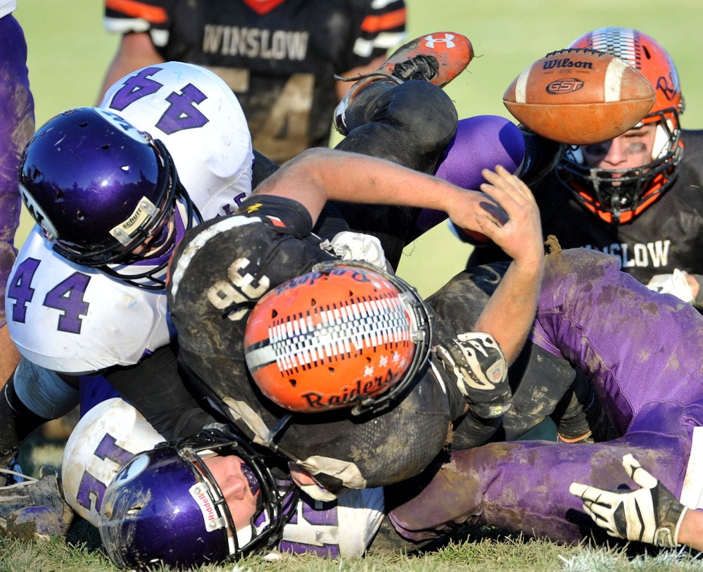 Staff photo by Michael G. Seamans 
 Winslow running back Kenny Rickard, front, is tackled by a group of Waterville defenders during the Big Ten Conference championship game last season. Rickard and the Raiders will look to polish off a perfect regular season when they meet their rival Panthers on Saturday.