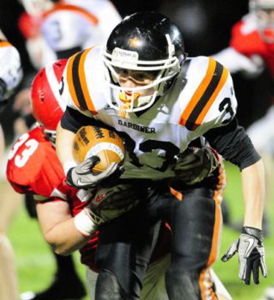 Gardiner’s Logan Clark tries to break free from Cony’s Reid Shostak during the annual rivalry game in Augusta. Both are back to play again tonight.