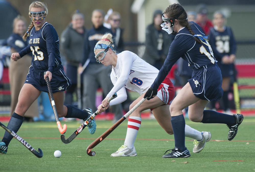 Kevin Bennett photo 
 Messalonskee’s Nathalie St. Pierre, center, splits the Mt. Blue defenders Hannah LeClair, left, and Gracie Foss and gets off a shot on goal during a Class A North semifinal game Saturday.