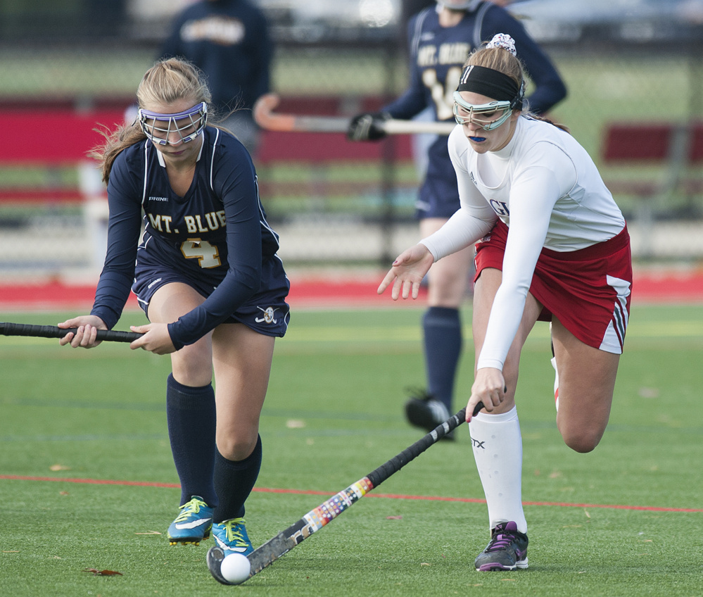 Kevin Bennett photo 
 Mt. Blue’s Jordyn Lawrence, left, and Messalonskee’s Emily Hogan chase the ball during the first half of a Class A North semifinal Saturday at Thomas College.