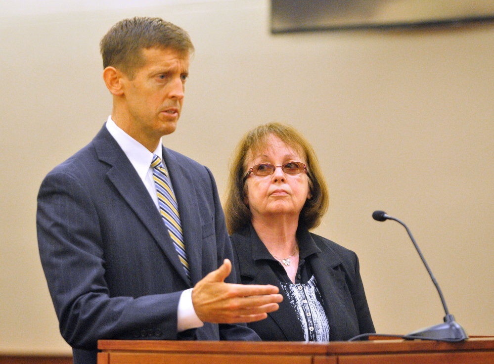 Attorney Walt McKee stands with Claudia Viles as she pleads not guilty plea in September in Kennebec County criminal court in Augusta. She is charged with 13 counts related to tax fraud and more than $400,000 missing from the Anson Town Office.