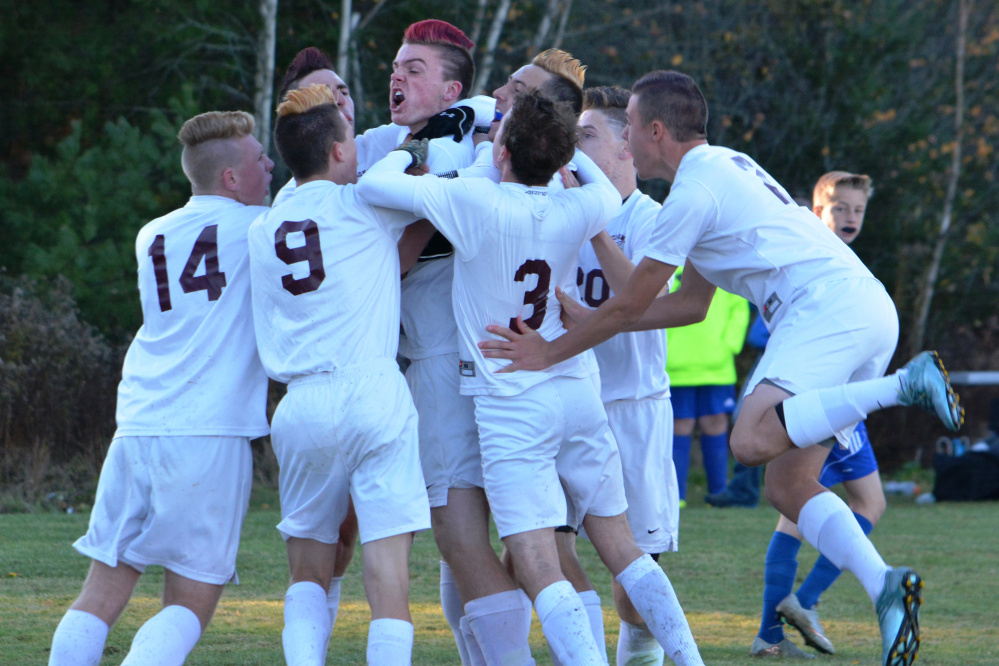 Richmond’s Matt Holt is mobbed by teammates after he scored his team’s first goal in a 4-1 win over Searsport in a Class D South semifinal game Friday.