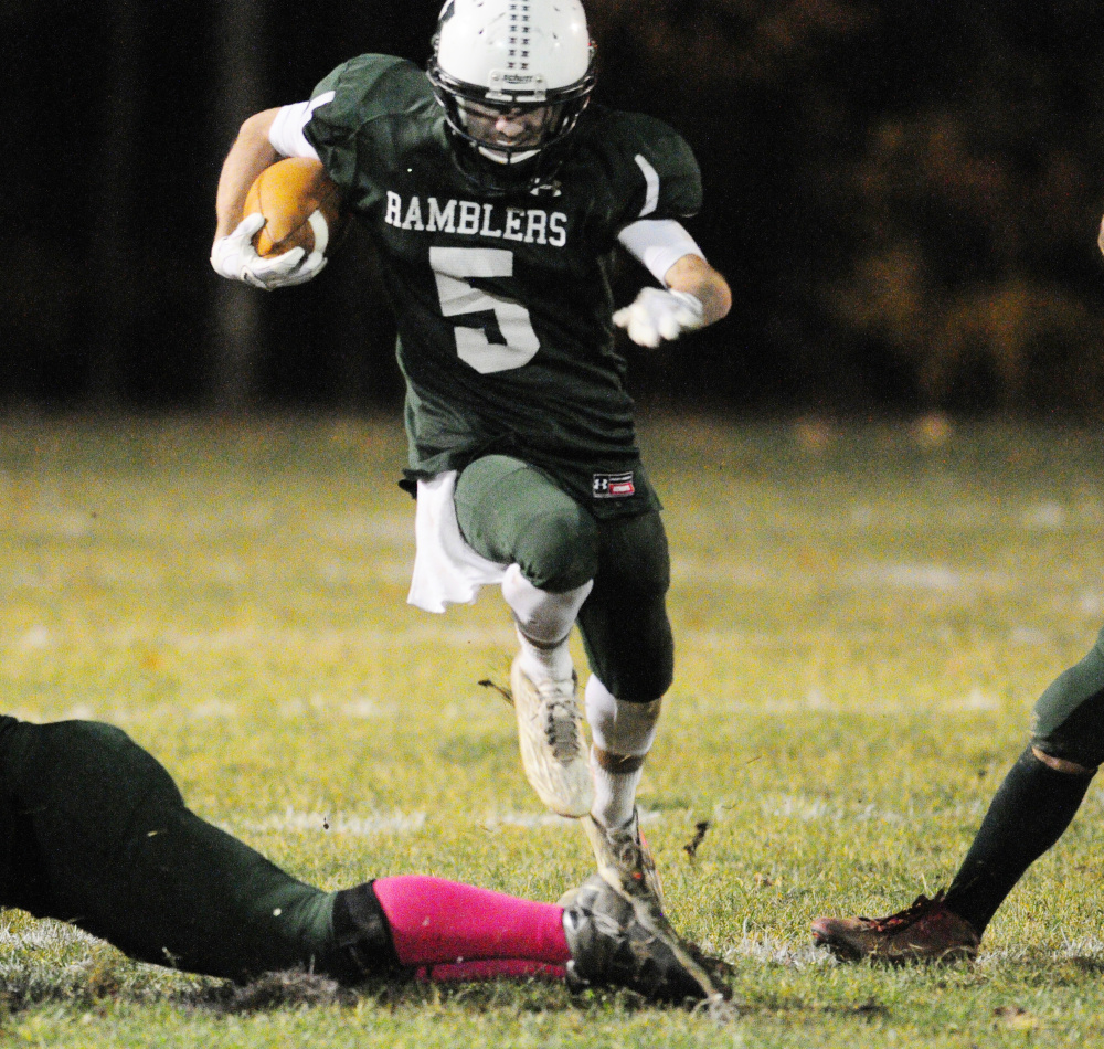 Winthrop/Monmouth running back Nate Scott runs through a hole during a Campbell Conference Class D quarterfinal game against Maranacook on Friday night at Maxwell Field in Winthrop.