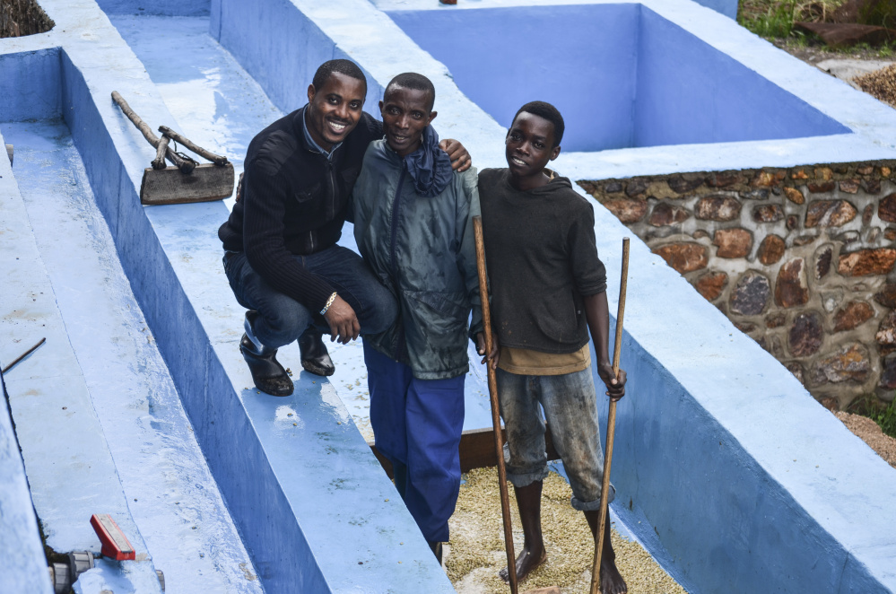 Rwanda Bean Co. founder Mike Mwenedata appears with coffee farmers in the western province of Karora in Rwanda.