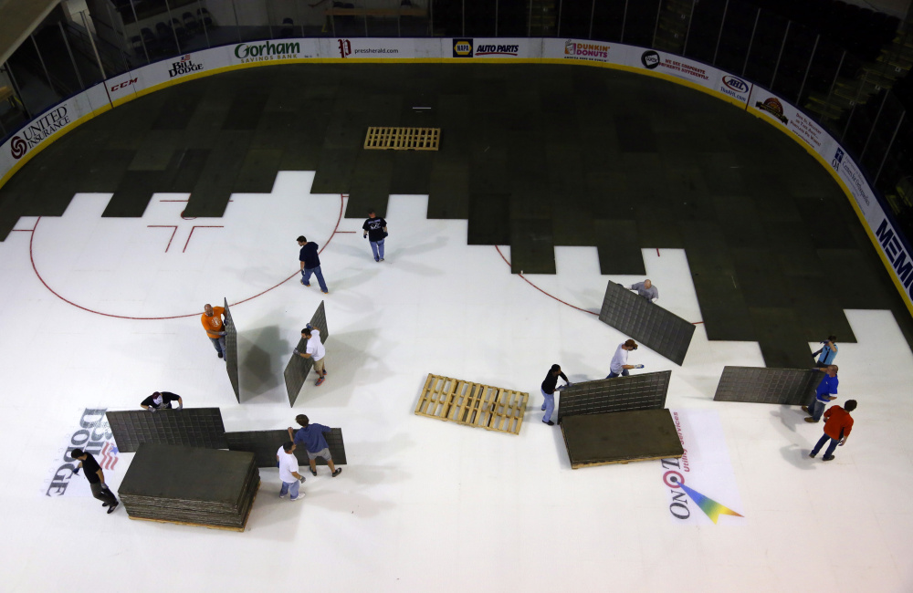 Crews prepare the ice at Cross Insurance Arena for a hockey game last October. A rink’s size and condition are factors in winning a bid to host NCAA Regionals.