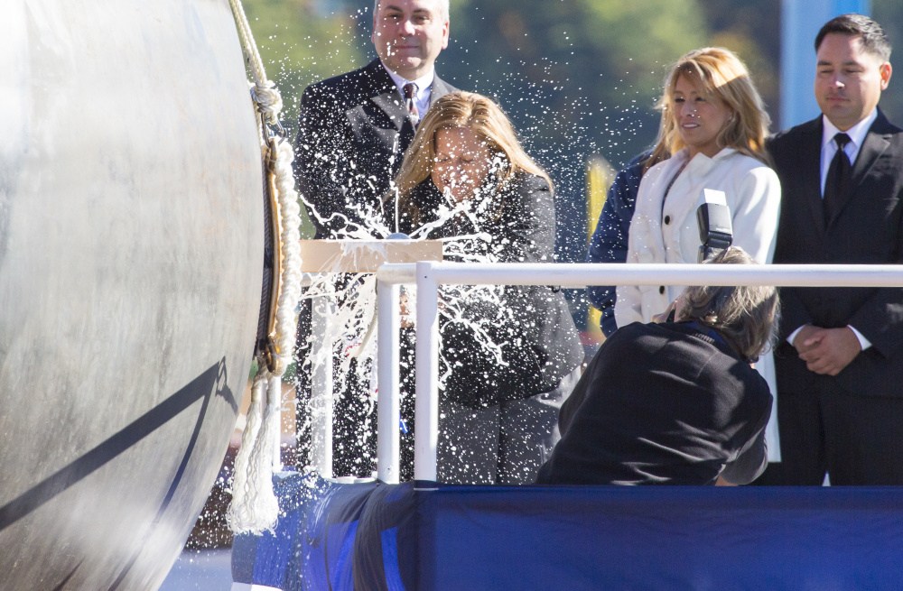 Rosa Peralta is flanked by family as she christens the USS Rafael Peralta on Saturday at Bath Iron Works. The ship is named for Peralta’s son, a U.S. Marine Corps sergeant who was killed in action in 2004 in Iraq. The ship is the 35th Arleigh Burke-class destroyer built at BIW.