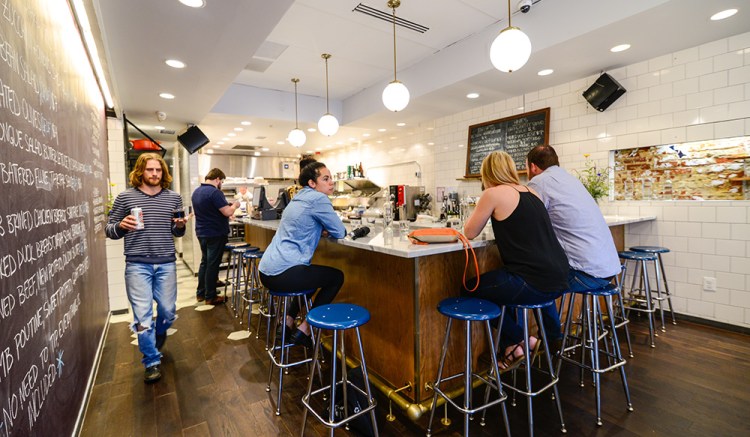 No tips are required at Sally's Middle Name in Washington, D.C.; instead, the staff splits an 18 percent service charge that is included in the bill. Photo by Dixie D. Vereen for The Washington Post