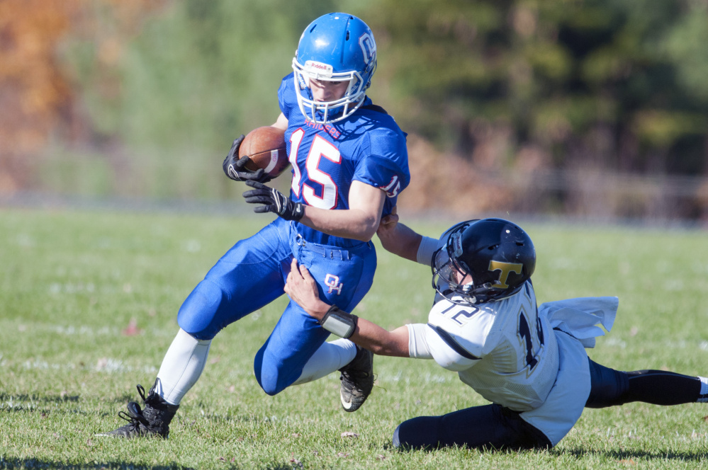 Staff file photo by Joe Phelan 
 Oak Hill running back Steve Gilbert, left, gets dragged down by Traip defensive back Angelo Succi during a Class D South quarterfinal Saturday afternoon. The Raiders won 48-6 and will next host Winthrop/Monmouth in the semifinals this Saturday.